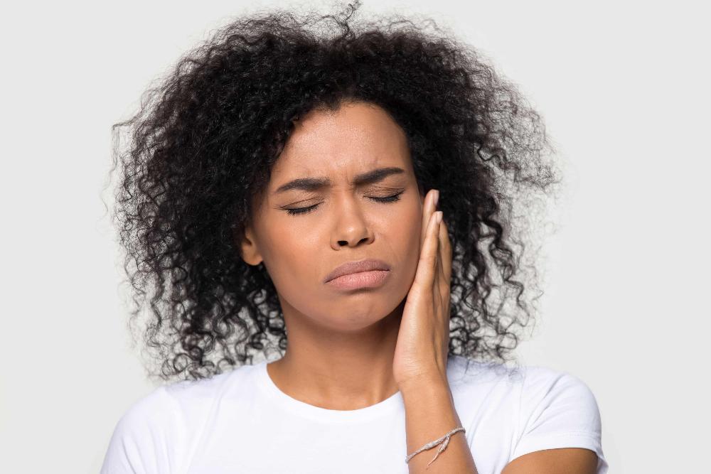 woman holding jaw from tooth pain before care at barrie dentist