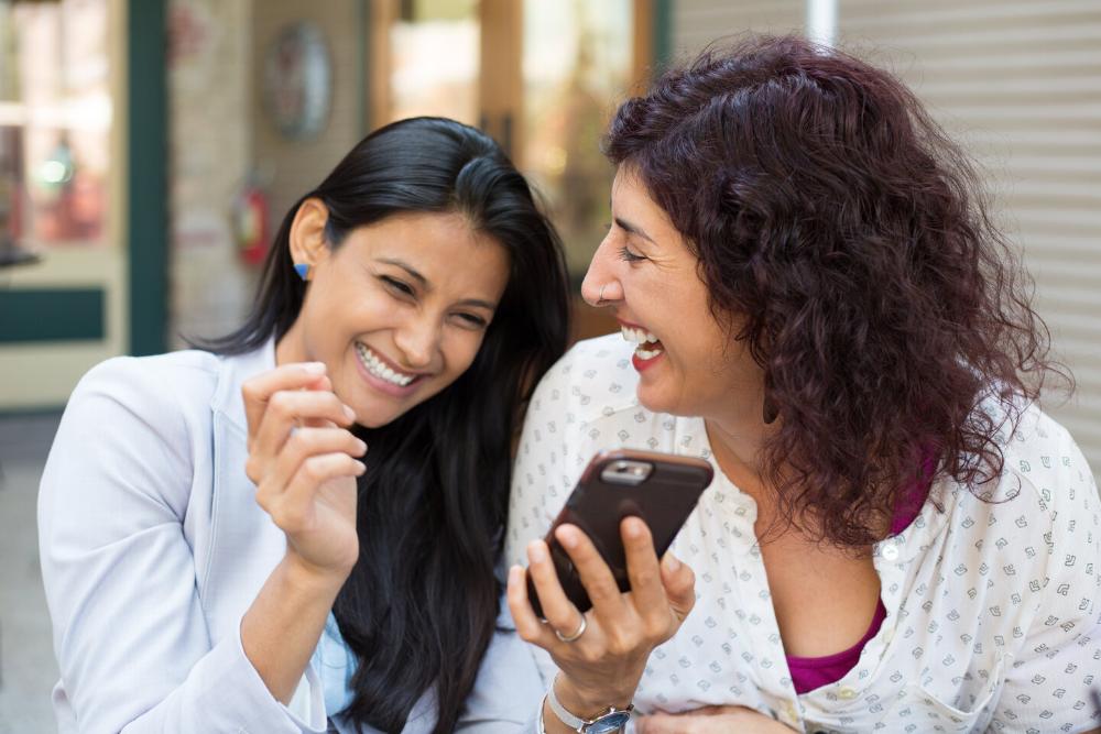 two woman laughing 
