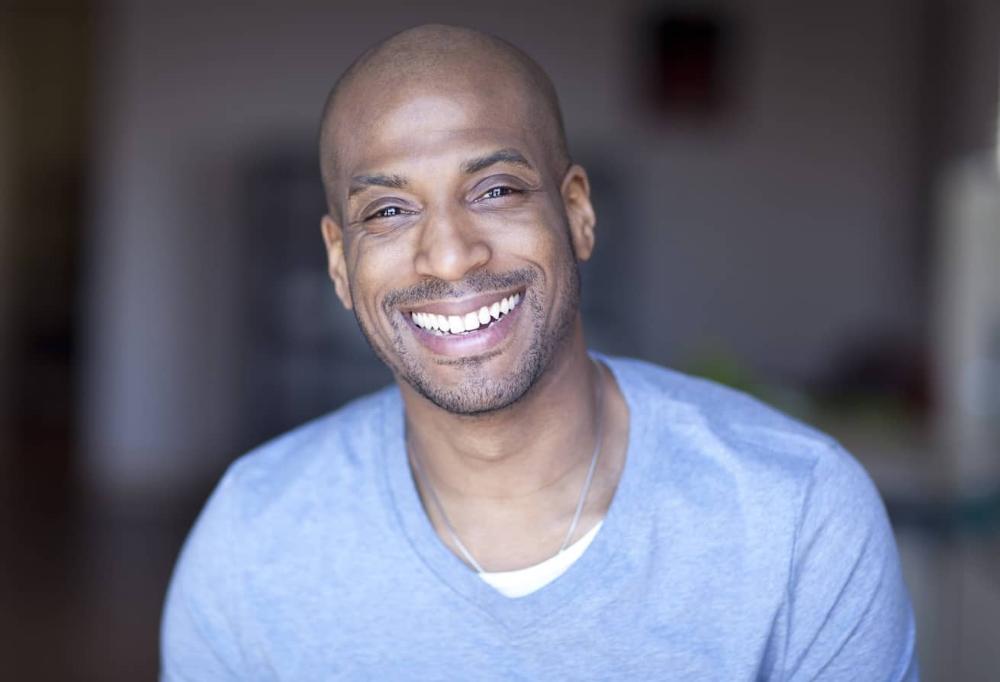 Barrie Man smiling in blue sweater