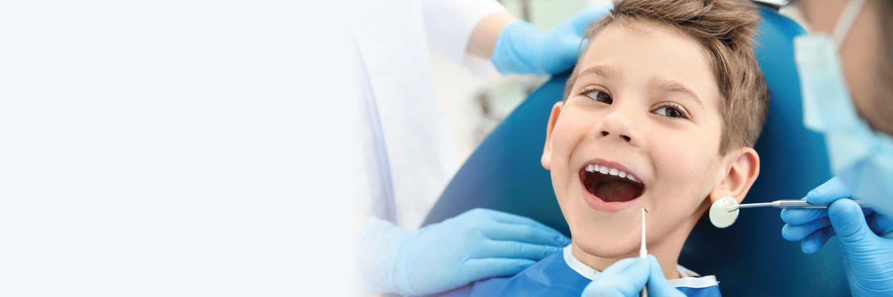 young boy sitting in dental chair getting first cleaning in barrie on