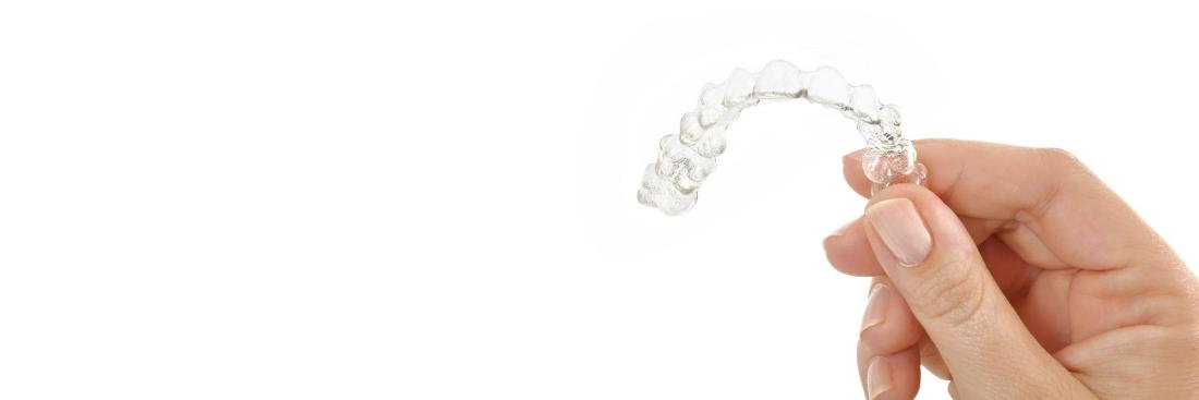 Hand holding Invisalign