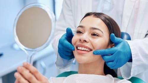 woman smiling after getting CEREC crowns in barrie